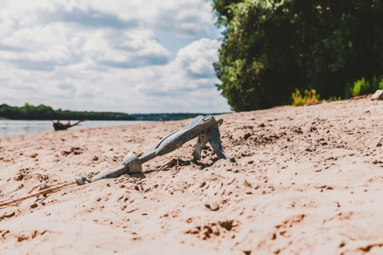 Anchor buried in sand symbolising legacy pay holding companies back