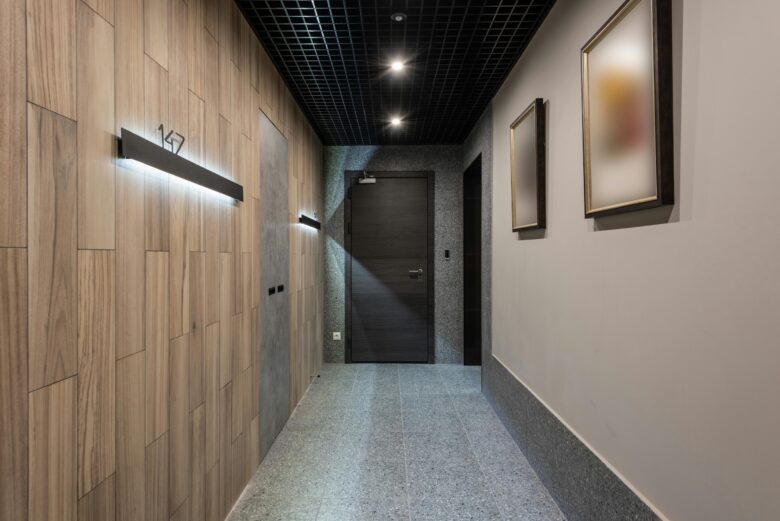 Modern corporate corridor with a closed office door, representing leadership accountability and management decisions.